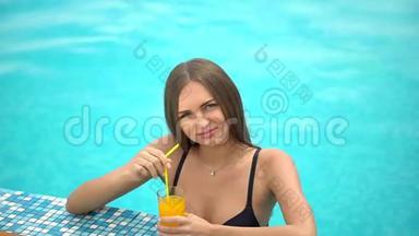夏天美丽的年轻女子。 比基尼<strong>女孩</strong>在热带<strong>游泳</strong>池放松。 <strong>喝</strong>着鲜橙的女人